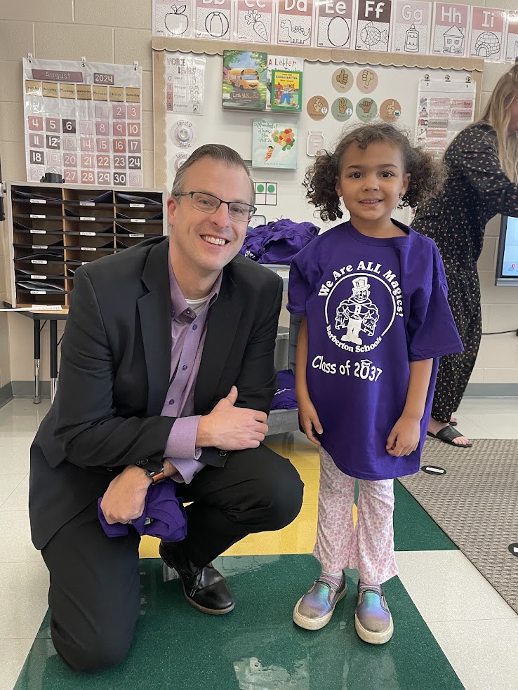 Josh Gordon with a new kindergarten student wearing a purple t-shirt