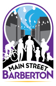 Main street barberton logo - white silhouette of people in front of a circle of downtown