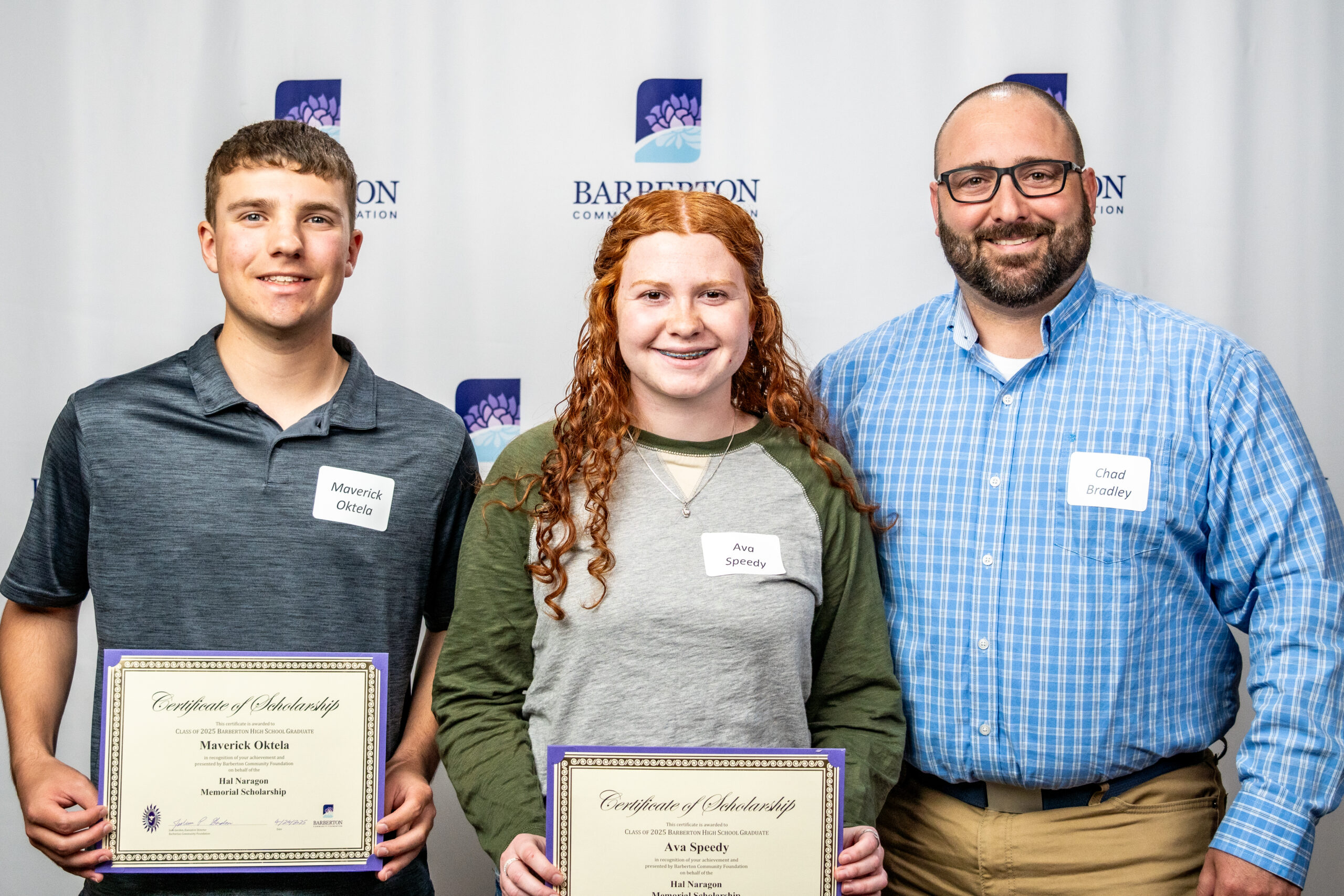 Barberton Community Foundation 2024 Cum Laude Scholarship Recipients: 25 students stand on stage holding certificates